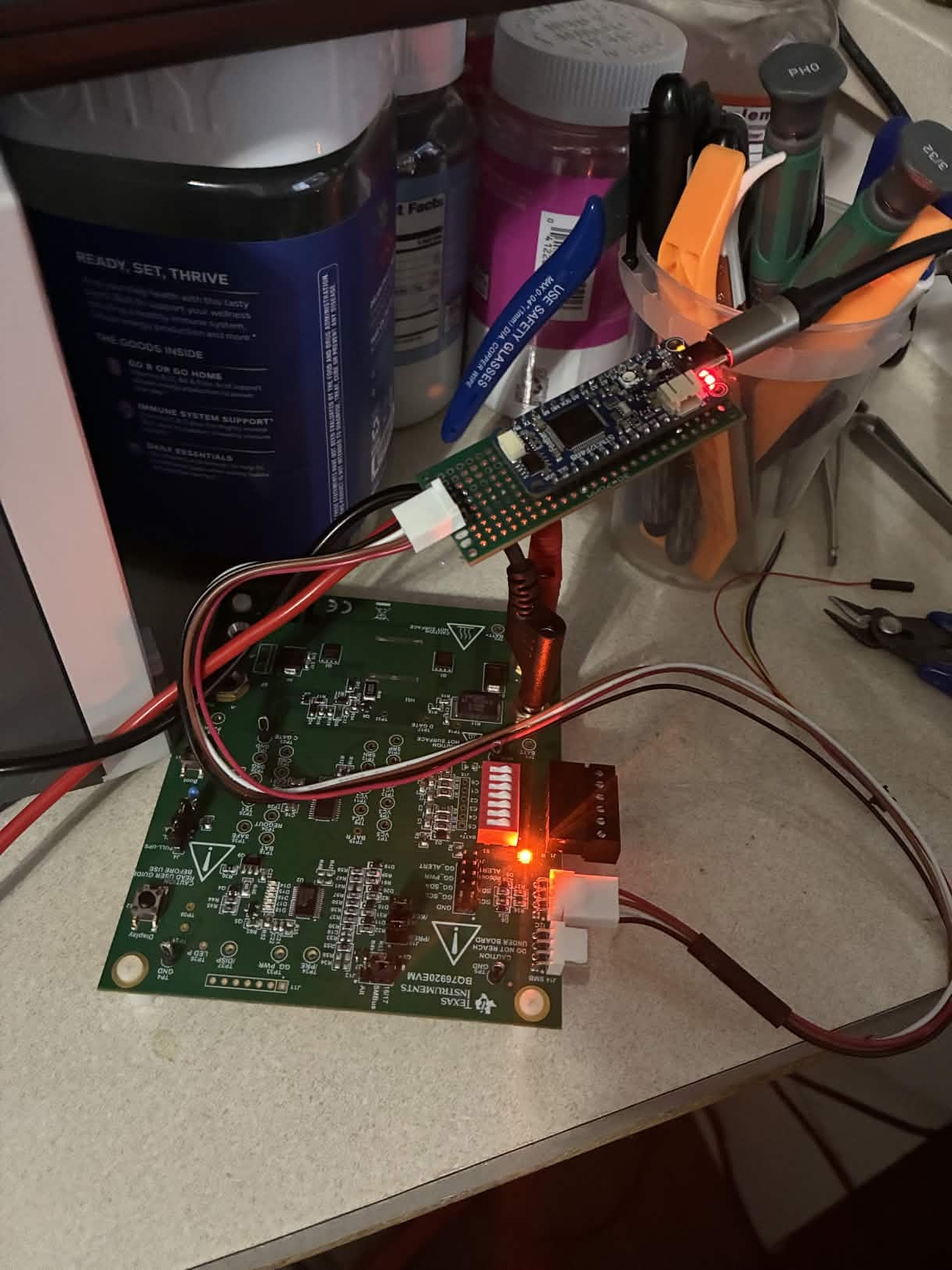 Front view: STM32 Feather connected to BQ76920 EVM via perf board breakout