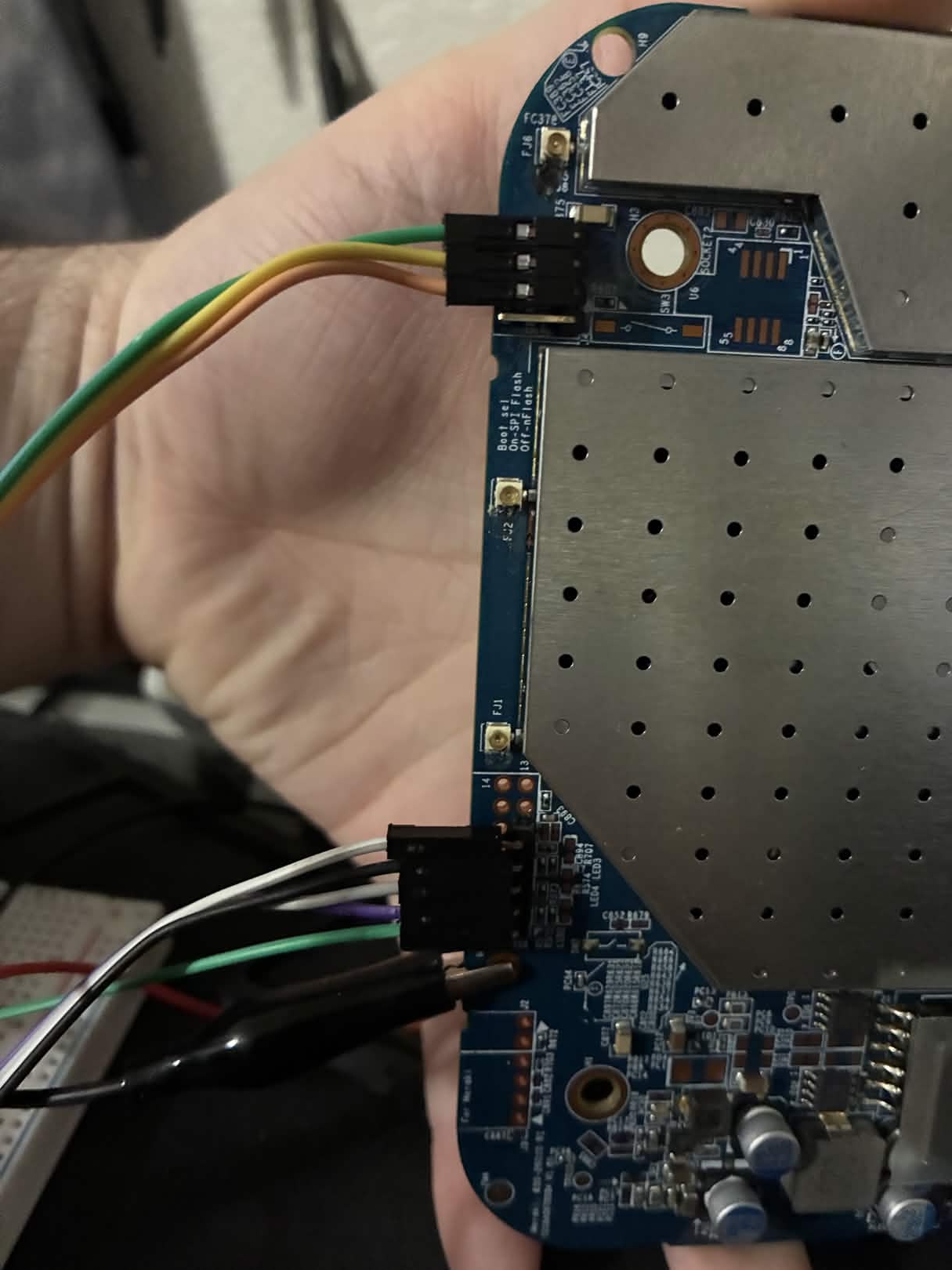 Back of the MR18 board showing both the J3 JTAG and J1 UART connectors with wires attached